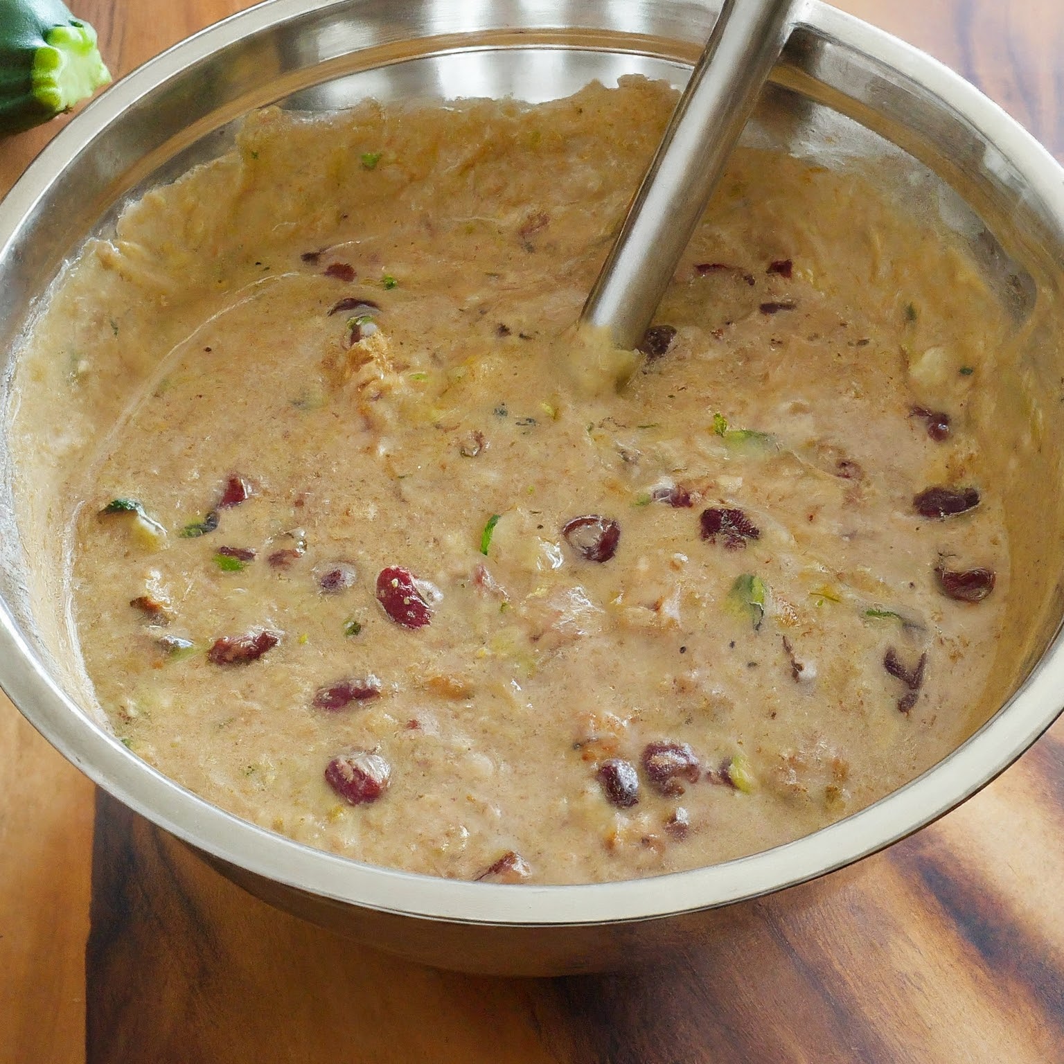 A slice of zucchini cranberry and walnut bread with almond flour